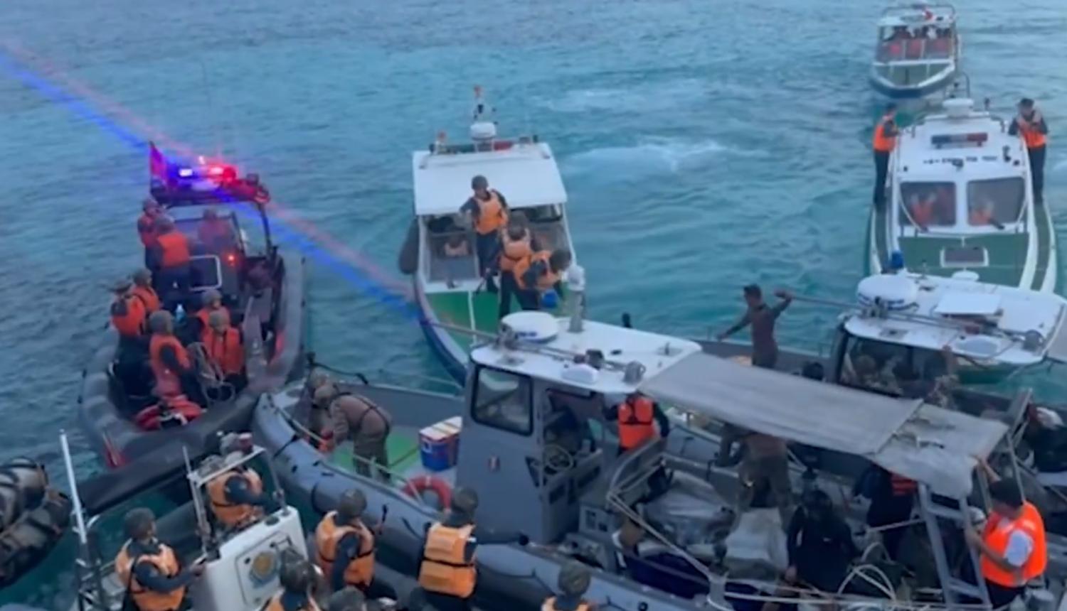 A still image taken from footage released overnight by the Armed Forces of the Philippines showing China Coast Guard confronting a resupply mission to Scarborough Shoal (@TeamAFP/X)